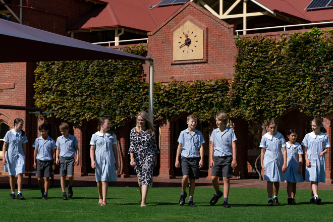 Students walking on grass