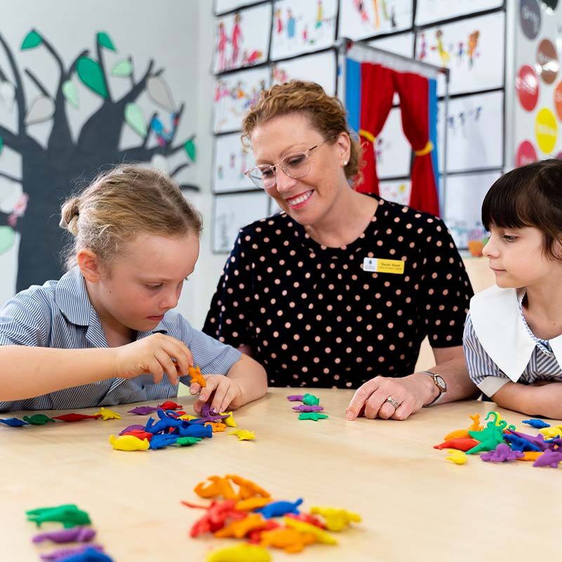 Staff member and students sorting small